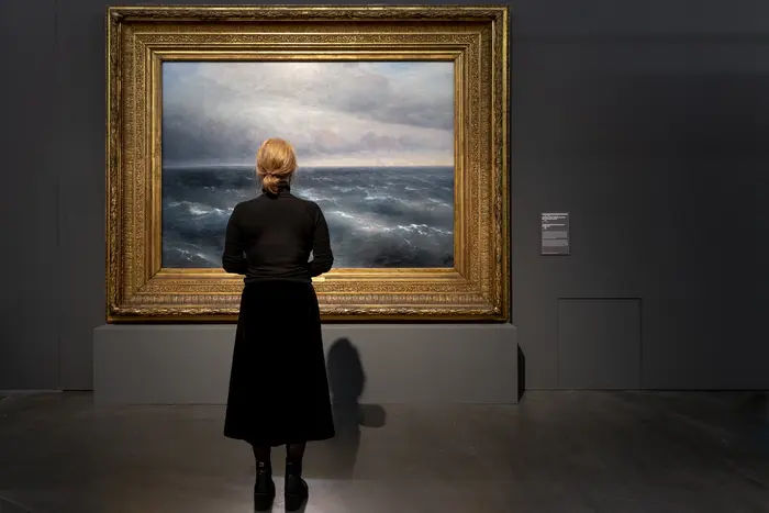 Eine Frau schaut sich ein Gemälde an 