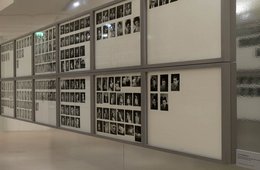 Blick in die Ausstellung Ein Ausstellungsraum mit vielen Schwarz-Weiß-Fotografien an den Wänden.