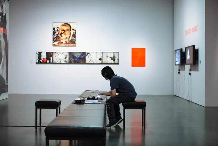 ein Besucher hört sich Musik in der Ausstellung an